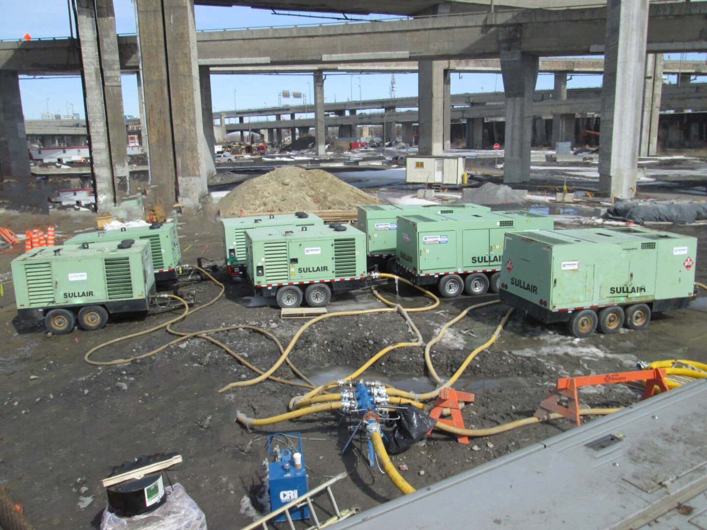 Large construction site Sullair Rental equipment. Tow behind models air compressors